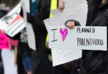 People holding signs supporting Planned Parenthood.