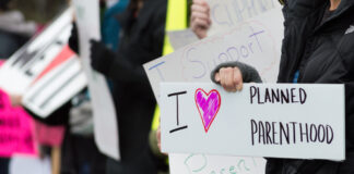 People holding signs supporting Planned Parenthood.