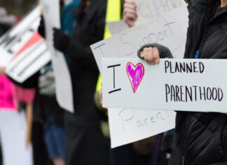 People holding signs supporting Planned Parenthood.