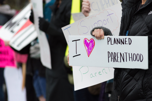 People holding signs supporting Planned Parenthood.