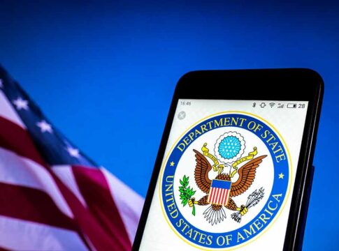 U.S. Department of State emblem on smartphone screen.