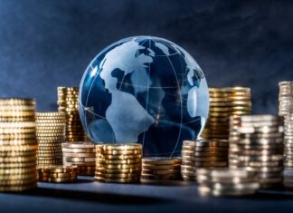 Glass globe surrounded by stacks of gold coins.