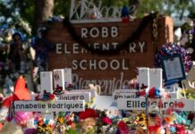 Memorial site at Robb Elementary School with floral tributes.