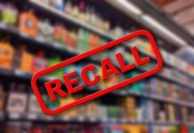 Recall sign over blurred grocery store shelves.