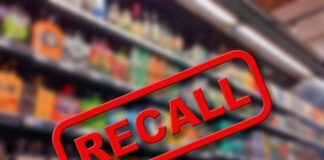 Recall sign over blurred grocery store shelves.