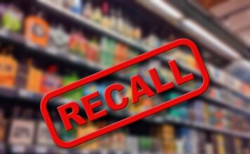 Recall sign over blurred grocery store shelves.