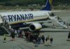 Passengers boarding a plane at the airport.