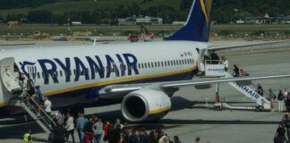 Passengers boarding a plane at the airport.