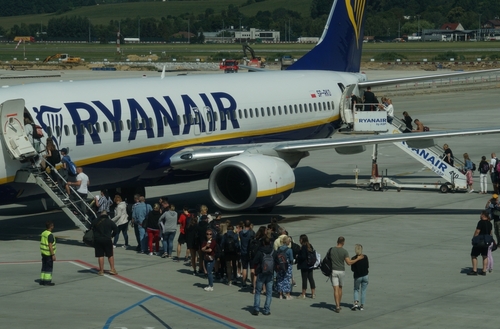 Passengers boarding a plane at the airport.