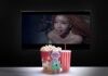 Stuffed toy with popcorn, soda, TV displaying mermaid scene.