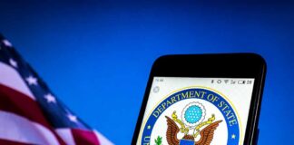 U.S. Department of State emblem on smartphone screen.