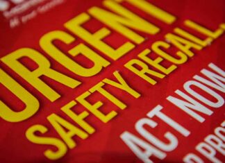 Urgent Safety Recall sign on red background.