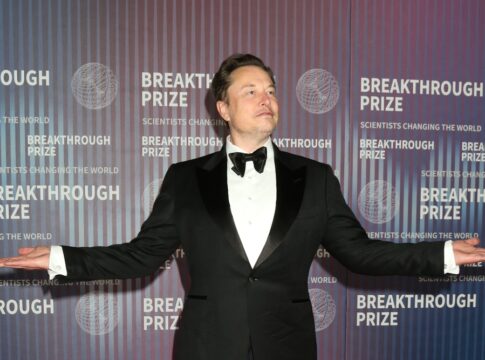 Person in tuxedo posing at Breakthrough Prize event