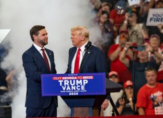 Two men at a political rally stage event