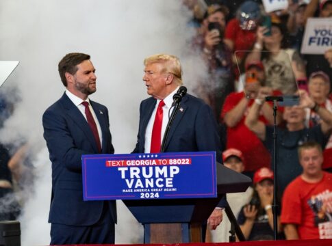 Two men at a political rally stage event