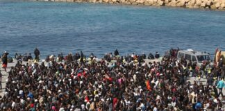 Large crowd gathered near a waterfront.