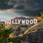 ARRESTED: What Hollywood Did to This Star… Hollywood sign on hills under cloudy sky.