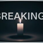 A candle illuminated against a dark background with the word 'BREAKING' displayed above it