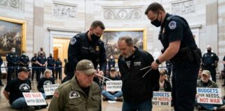 Veterans being arrested during a protest in the Capitol building