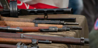 Old rifles displayed on a table