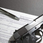 Prosecutor REFUSES NEW Assault Weapons BAN – Chaos in Virginia…. Form with gun and pen on table.