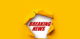 Breaking News text on yellow torn paper background.