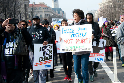 shutterstock237428068jpg Protesters holding signs, including Police Should Protect Not Murder.