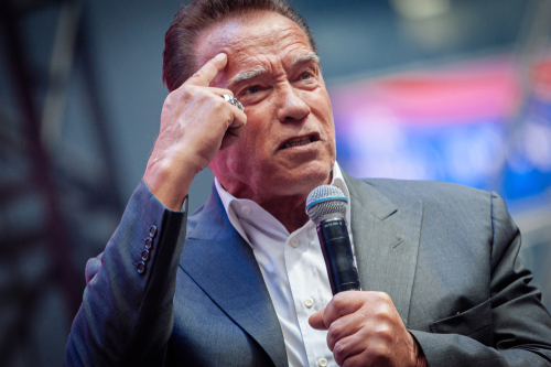 Saint,Petersburg,/,Russia,-,10.04.,2019:,Arnold,Schwarzenegger,At man in suit speaking into a microphone on stage