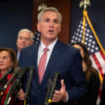 A group of people speaking at a press conference.