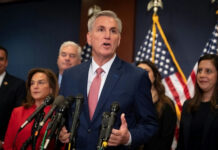 A group of people speaking at a press conference.