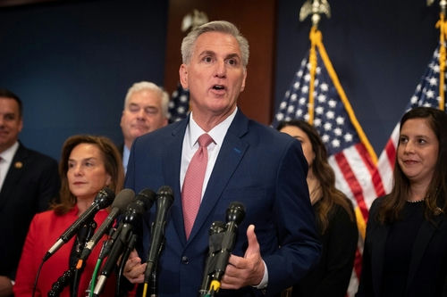 A group of people speaking at a press conference.