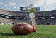 NFL trophy and football on the field in a stadium