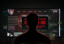 A person sitting in front of a computer screen displaying warning messages and code