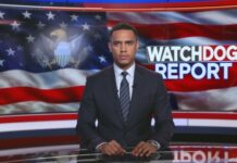 News anchor presenting a report in front of an American flag backdrop
