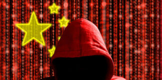 A hooded figure in a red hoodie against a backdrop of binary code and stars representing China