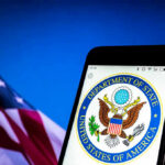 U.S. Department of State emblem on smartphone screen.