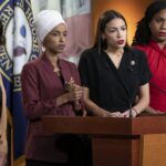 Four women politicians speaking at a press conference