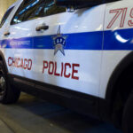 Chicago Police vehicle parked on city street at night.