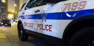 Chicago Police vehicle parked on city street at night.