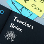 Notebook labeled Teachers Union with office supplies.