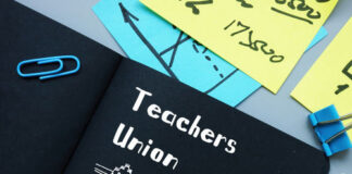 Notebook labeled Teachers Union with office supplies.