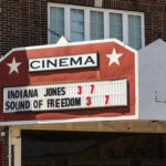 Censorship Clash Erupts — Musk Drops Full Movie Cinema marquee on a brick building displaying current movie titles and showtimes
