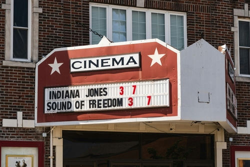shutterstock2330520145-1jpg Cinema marquee on a brick building displaying current movie titles and showtimes