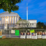 FBI Storms Campus Activists’ Homes Protest signs outside the U.S. Supreme Court building.
