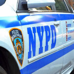 Cameras Roll, Arrests Stall Close-up of a NYPD police car.