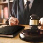 Judge with gavel striking sound block