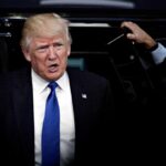 Warren Targets Trump Library Money Trail man in suit stepping out of a vehicle