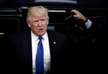 Warren Targets Trump Library Money Trail man in suit stepping out of a vehicle