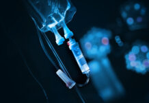 Close-up of an IV drip setup with a blue background