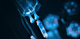 Close-up of an IV drip setup with a blue background